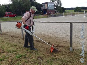 Gebhard hat sein Gerät umgestellt und fährt harte Geschütze auf, um den Teppich um den Reitplatz wieder grasfrei zu bekommen...